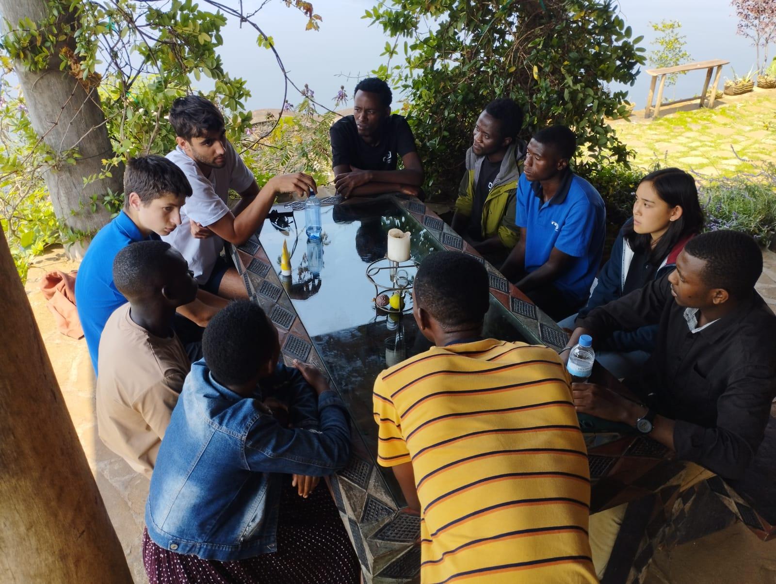 An outdoor workshop with young people seated in a circle during the 2025 program.