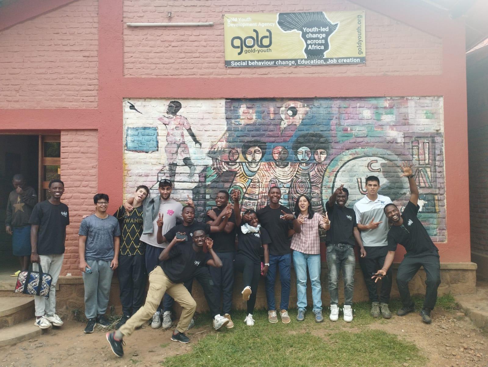 Group photo of students and peer educators outside a gold-youth center in 2025.